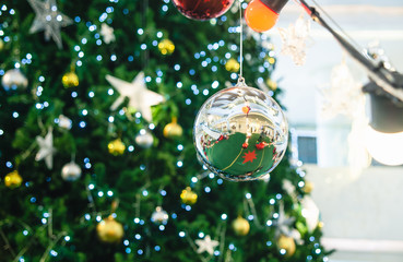 Silver ball hanging on Christmas tree.