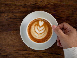 coffee latte with beautiful latte art on hand