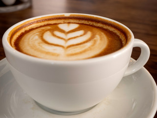 Hot coffee with soft bubble on old wooden boards.