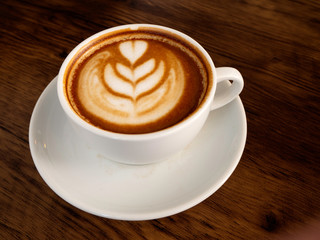 Hot coffee with soft bubble on old wooden boards.