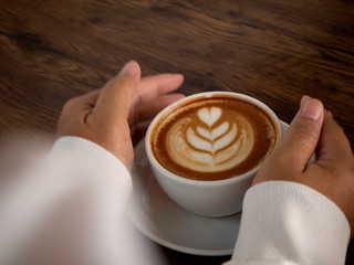 coffee latte with beautiful latte art on hand