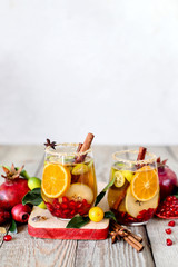 Sangria with pomegranate, pear, orange, kumquat and spices.