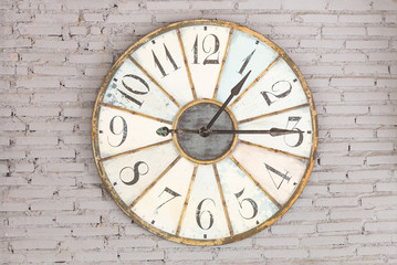 Retro clock showing one fifteen on the wall