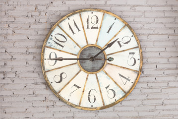 Retro clock showing one forty five on the wall