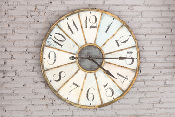 Fototapeta na wymiar Retro clock showing four fifteen on the wall