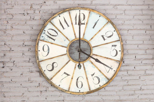 Retro clock showing four oclock on the wall