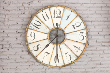 Retro clock showing seven thirty on the wall