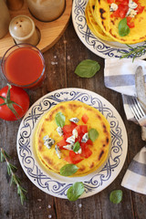 Oriental cuisine. Salty flat cakes with blue cheese and tomatoes, two portions