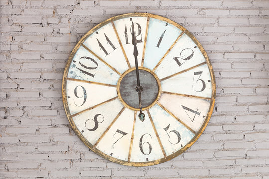 Retro clock showing twelve oclock on the wall