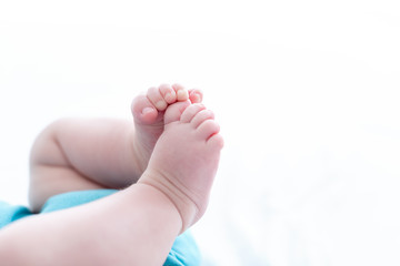 The feet of a young baby boy - no face