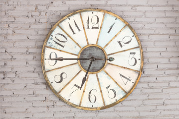 Fototapeta na wymiar Retro clock showing six forty five on the wall