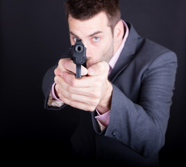 Man in suit with gun