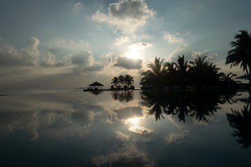 Beautiful poolside and sunset sky. Luxurious tropical beach landscape and water reflection