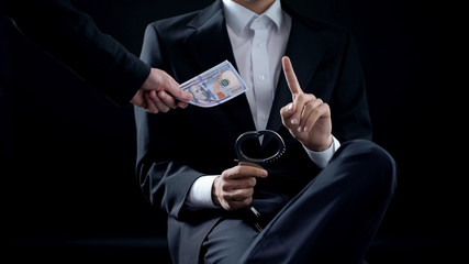 Male with handcuffs refusing to take bribe, inevitable punishment, illegal deal