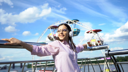 Beautiful woman listening to motivating audiobook in headphones, inspiration