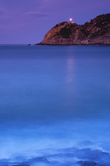 light of Getaria lighthouse over the sea at night, Euskadi