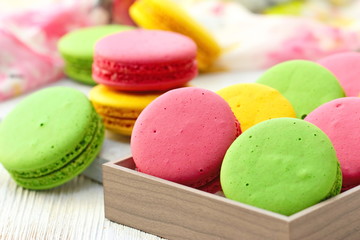 Colorful macaroons on wooden table. Sweet dessert