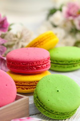 Colorful macaroons on wooden table. Sweet dessert