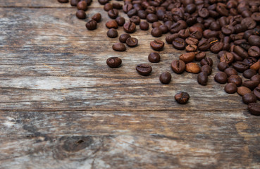 Coffee beans on old wood background