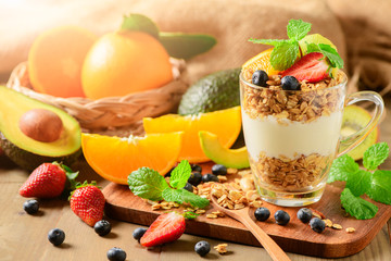 Granola and yogurt and fruits on topping in glass