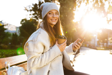 Beautiful young woman dressed in autumn coat and hat