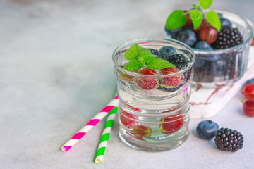 Carbonated drinks in glass with fresh berries.