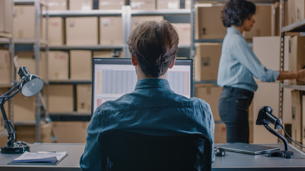 Warehouse Inventory Manager Talks to a Clerk Working with a Spreadsheet on a Personal Computer...
