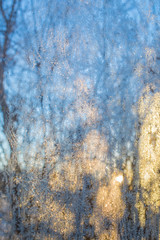 Frost on a window with a sunset in the background