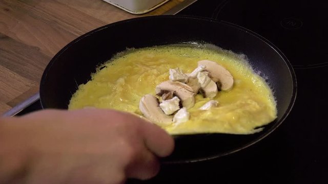 Mushroom & cheese omelette is folded and served on a plate