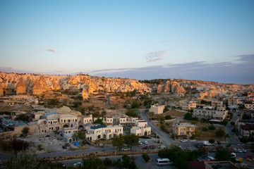 Fototapeta premium Aerial view on Sunrise over Cappadocia. Balloons flying against blue sky. Goreme most popular place in Turkey 