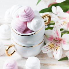 Delicious white and pink marshmallows in cup.