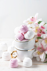 Fototapeta na wymiar Delicious white and pink marshmallows in cup.