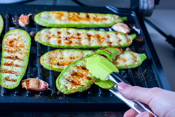 Grilled zucchini on a grill close-up.