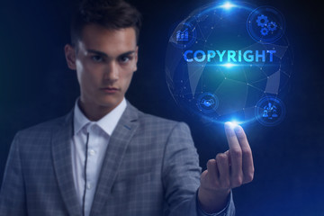 The concept of business, technology, the Internet and the network. A young entrepreneur working on a virtual screen of the future and sees the inscription: Copyright