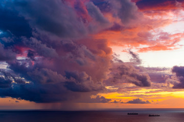 Obraz premium Magnificent colored clouds on the sea at sunset in the evening