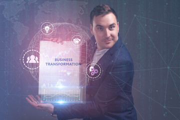 The concept of business, technology, the Internet and the network. A young entrepreneur working on a virtual screen of the future and sees the inscription: Business transformation