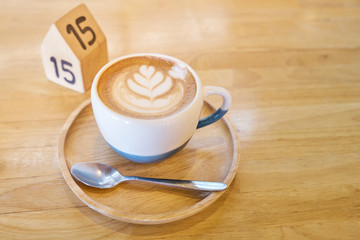 Coffee cup on wood table with natural light and copyspace