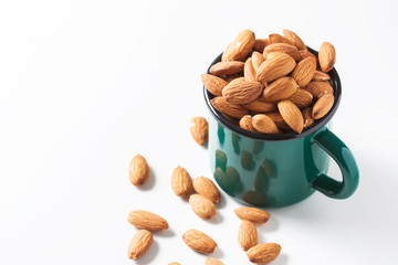 Almonds in a bowl isolated on white background. Healthy snack.