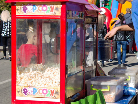 A Young Man Sells Popcorn And Cotton Candy In The Square.