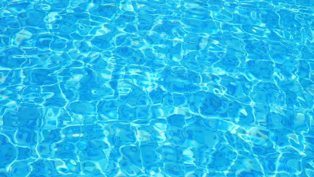 Ripple on blue water in the pool with light reflections.