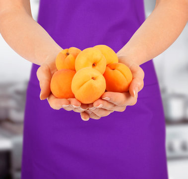 WOMAN HOLDING APRICOTS