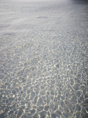 Photo of the amazing crystal clear water, in the shallow shimmering part of the pristine beach of Redang Island. Popular for snorkelling tourism.