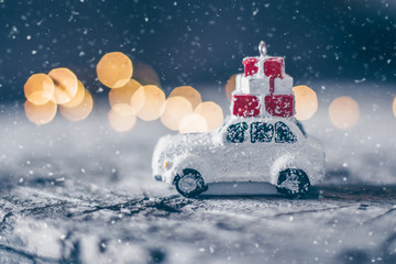 Christmas Card Holiday Concept with toy car and magic bokeh. Copy space. Abstract Background. Toned Snow Image