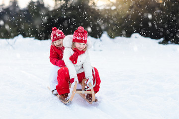 Kids on sleigh. Children sled. Winter snow fun.