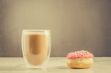 donut in red glaze and a cappuccino/donut in red glaze and a glass with a cappuccino