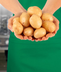 WOMAN HOLDING NEW POTATOES