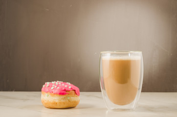 donut in red glaze and a cappuccino/donut in red glaze and cappuccino on a dark background with copy space