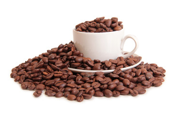 Coffee beans and a white cup on white background