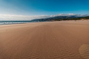 Fototapeta na wymiar Wide beach by the ocean to surf