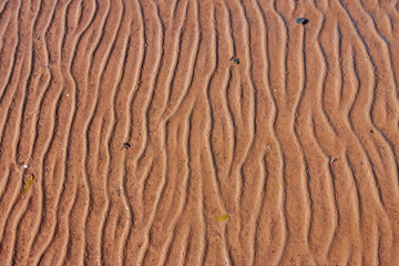 A brown river sand background with curve lines pattern texture